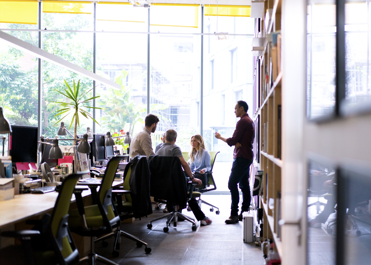 Photo of male and female professionals working together at workplace.